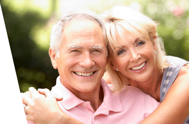 An older couple embracing while smiling