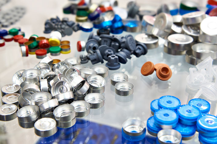 A group of assorted medical device parts in plastic and rubber and metal